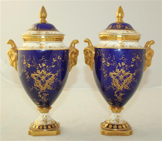 A pair of Coalport fruit painted pedestal vases and covers, post war, 24cm